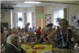 Group Sitting and Standing at Yellow Table