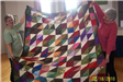Woman Holding Multicolor Quilt