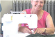 Woman Smiling While Using Sewing Machine