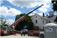 Workers and a Crane in Front of Building