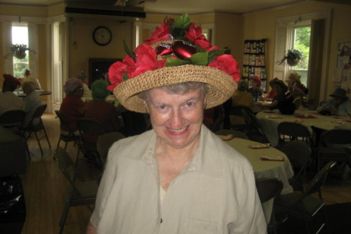 Woman Wearing Hat with Red Flowers