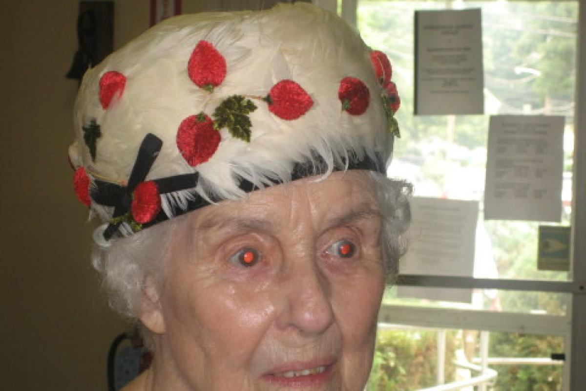Woman Wearing White Hat with Red Leaves