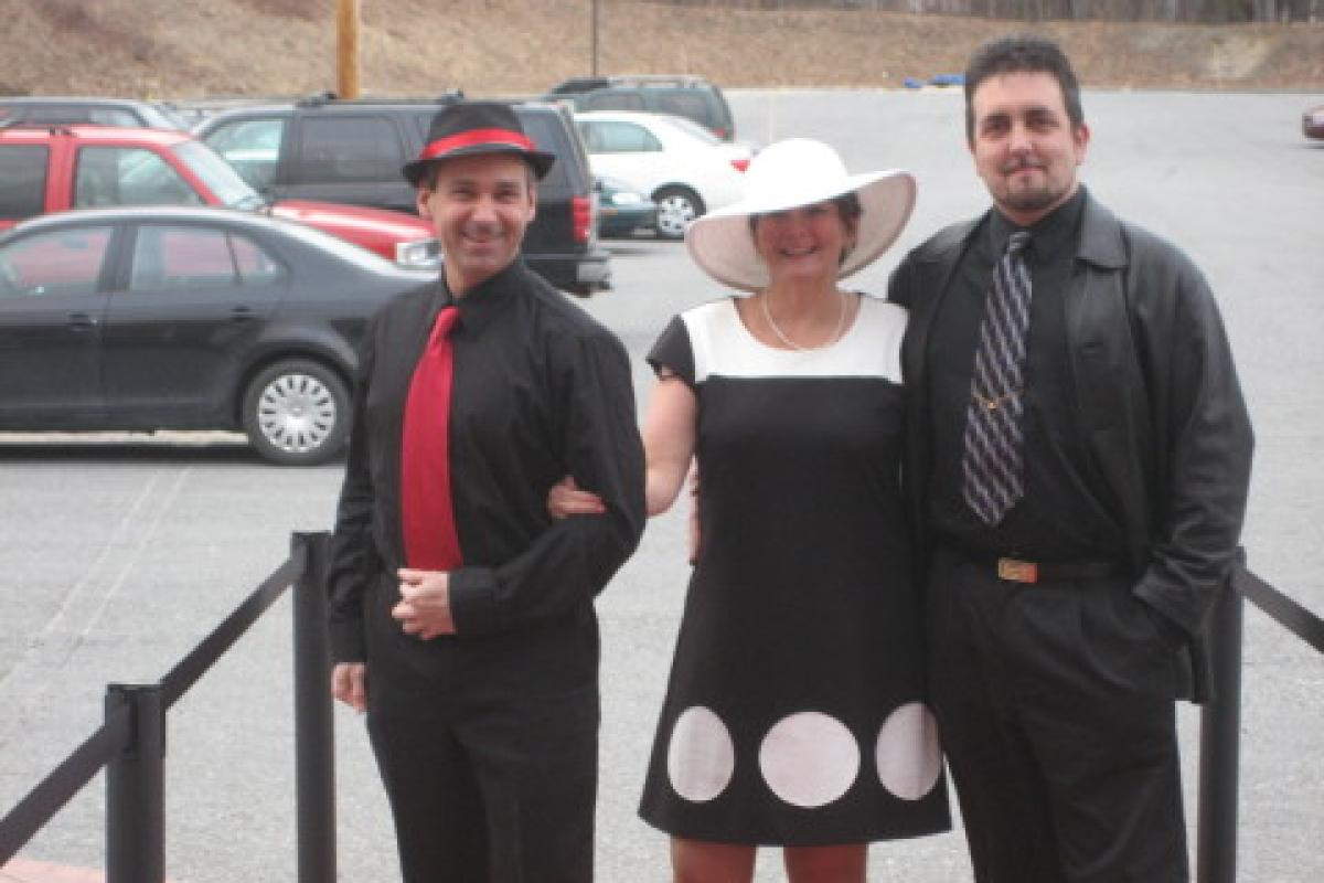 Group of Three Smiling on Red Carpet