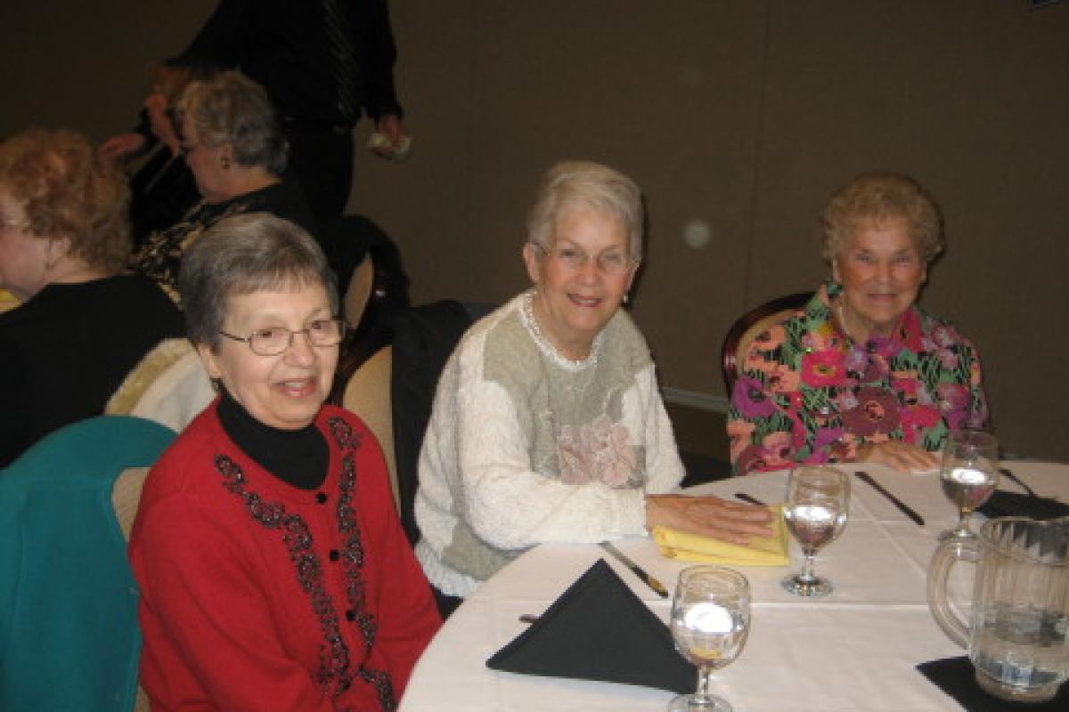 Three Women Sitting and Smiling