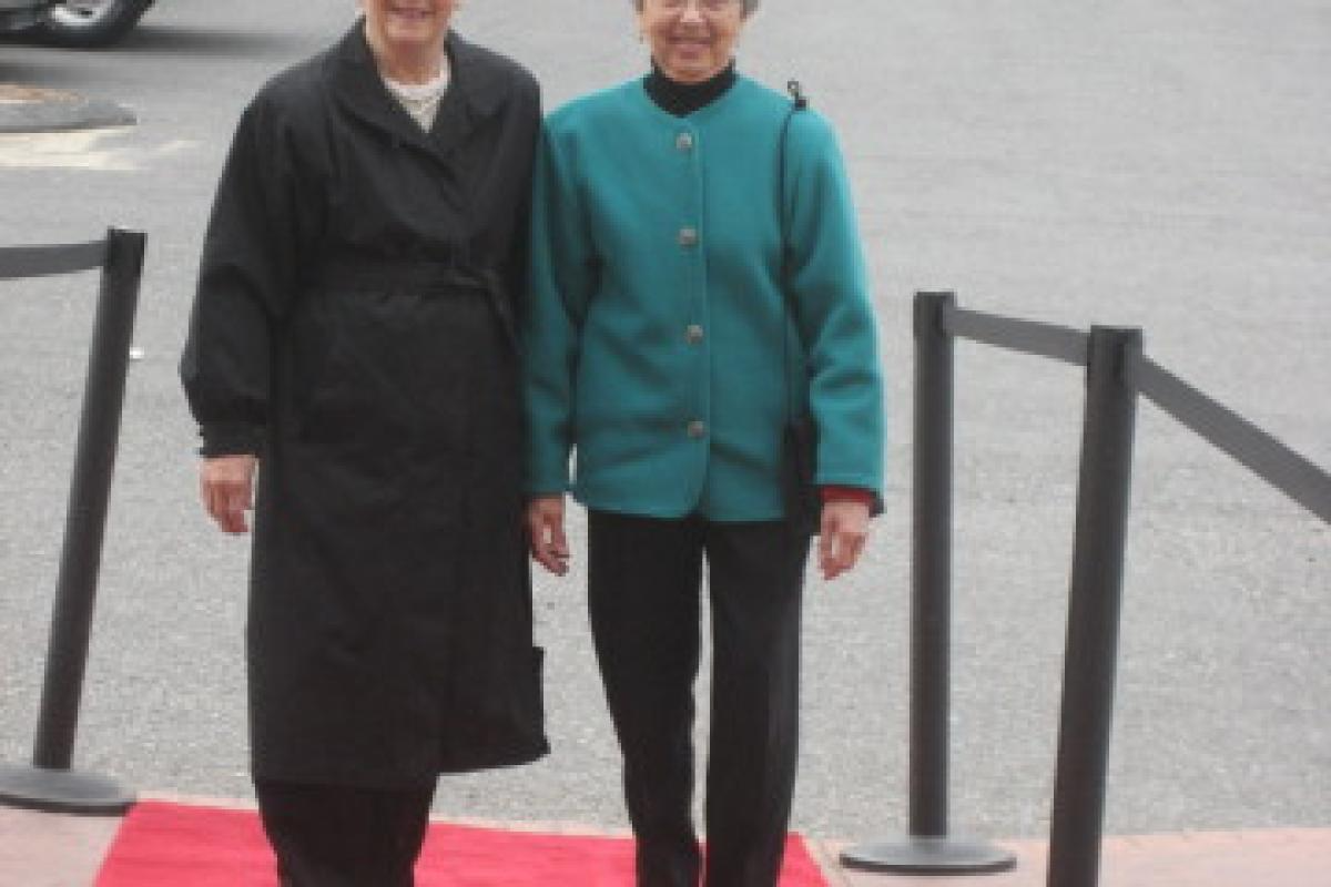 Two Women Dressed in Black and Green