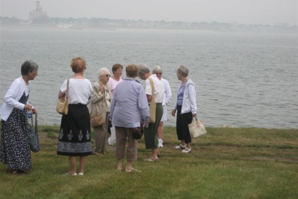 Group of Women Standing by the Water