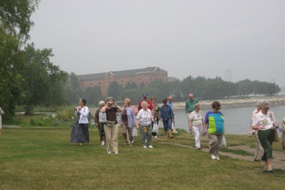 Group Standing in the Grass with Building in the Distance