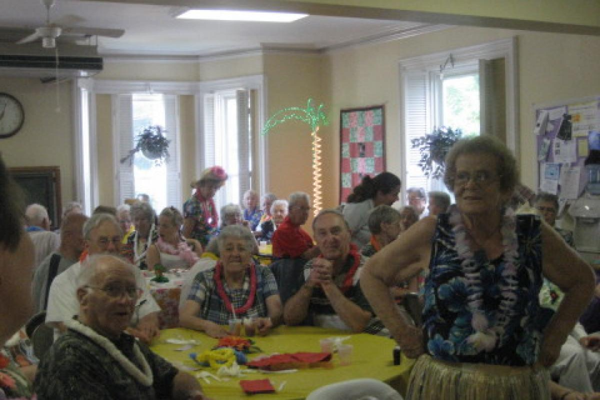 Group Sitting and Standing at Yellow Table
