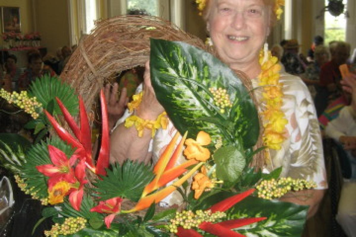Woman Holding Wreath with Flowers