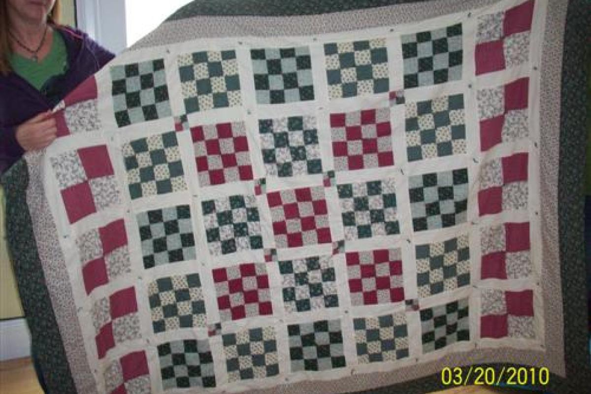 Woman Holding Red and Blue Quilt
