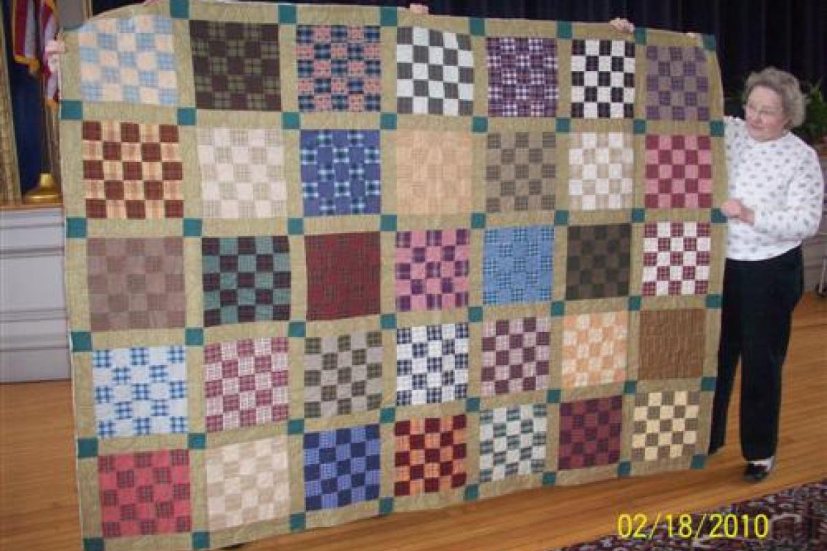 Woman Next to Printed Quilt