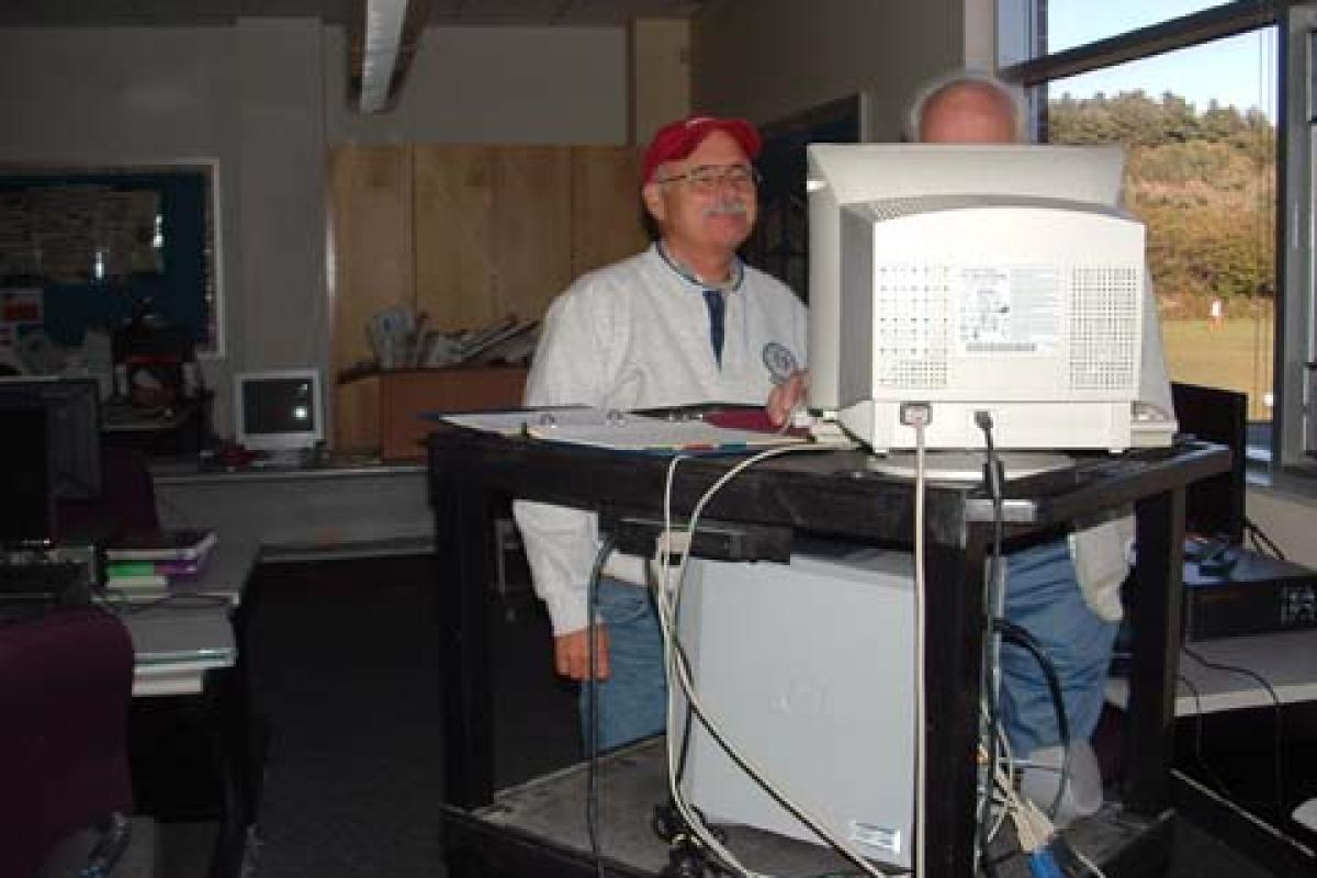 Men Standing and Looking at Computer