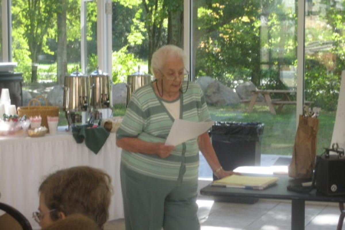 Woman Reading from Paper